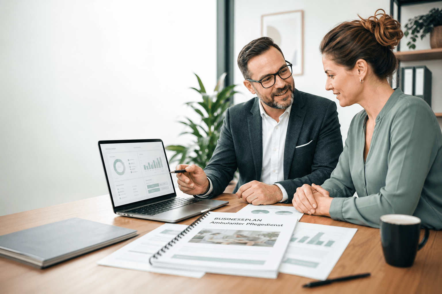 Beratungsszene mit Laptop und Businessplan für Pflegegründung